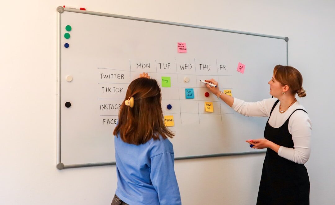 Journalist planning a story on a whiteboard in a media office